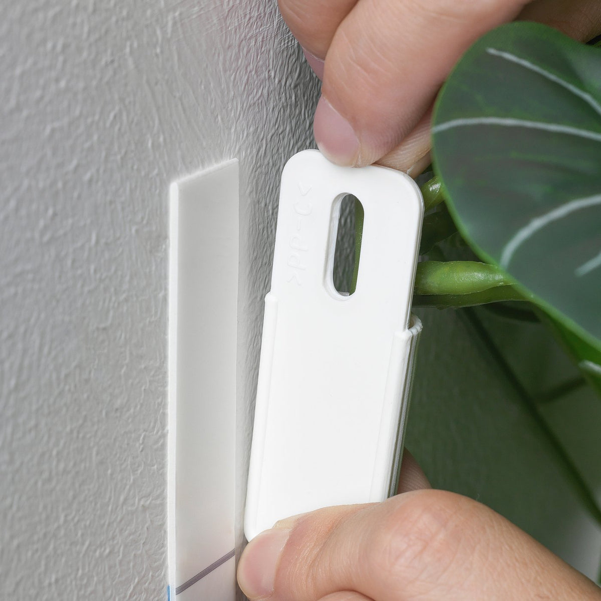 Artificial plant with wall holder