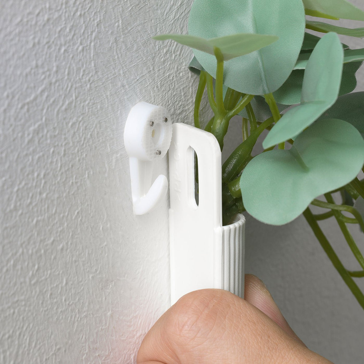 Artificial plant with wall holder