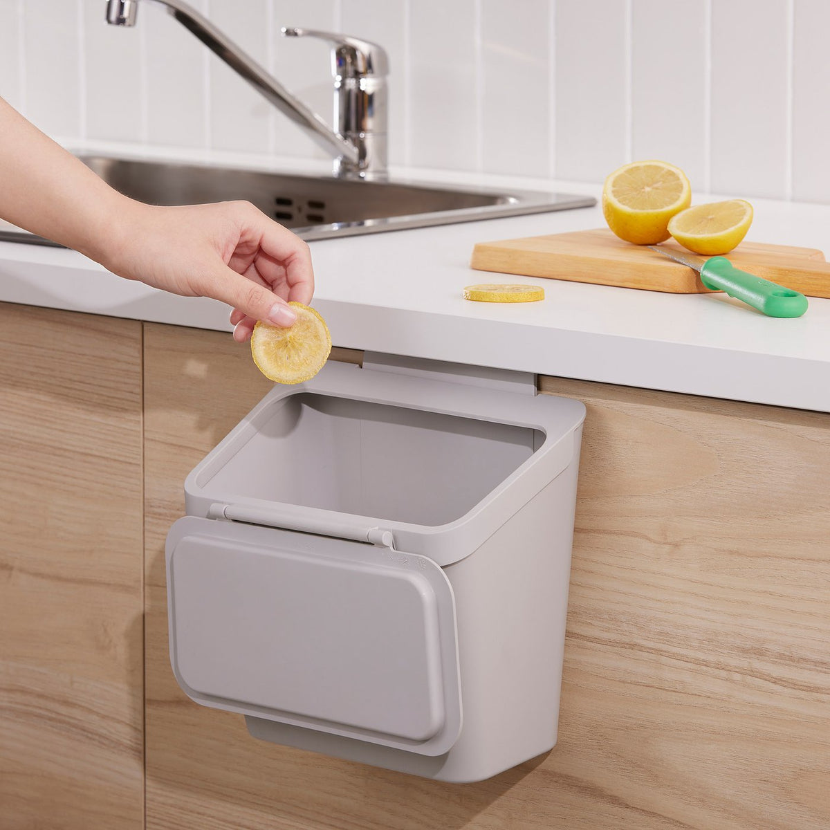 Waste bin for cabinet with door